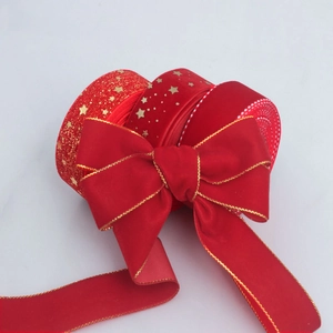 Red velvet Christmas ribbons with gold star patterns and bows for festive gift wrapping