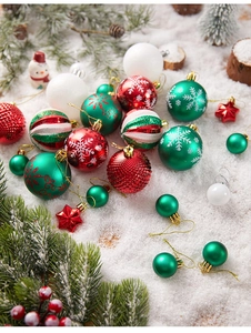 Detail of red and green Christmas ball ornaments with snowflake patterns and glitter stars