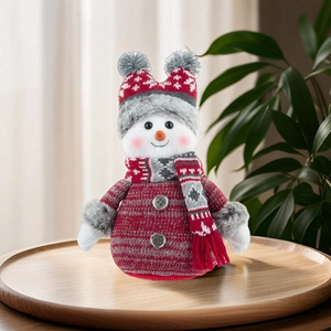 Knitted Christmas snowman doll ornament in striped sweater and scarf for home holiday decor