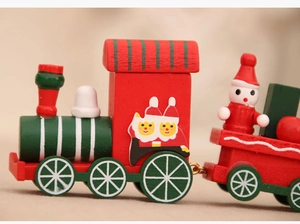 Close-up of a festive wooden Christmas train set featuring snowman and Santa figurines