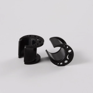 Macro shot of black hollow-out crescent moon ear gauges with smooth polished surface