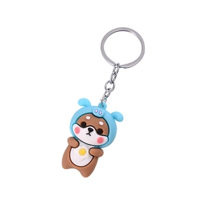 Cartoon Shiba Inu keychain with blue hoodie and brown body on white background