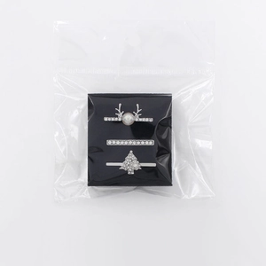 Three-piece silver ring set featuring reindeer, crystals, and Christmas tree charms