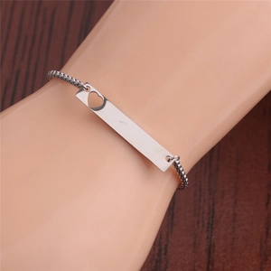 Adjustable silver titanium steel bracelet with heart cutout plate on model wrist