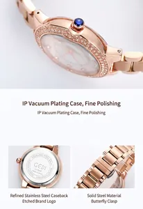 Detail of rose gold watch showing crystal bezel and stainless steel butterfly buckle