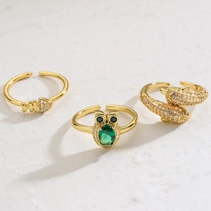 Adjustable gold plated animal rings set with owl dolphin and fishbone designs
