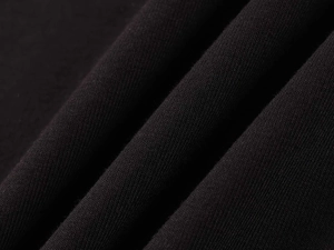 Macro detail of high-elastic black modal fabric with fine knit texture and soft drape