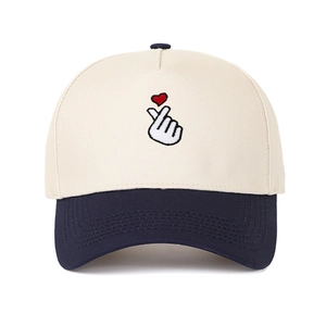 Detail showing finger heart embroidery and color-block design on twill cotton baseball cap