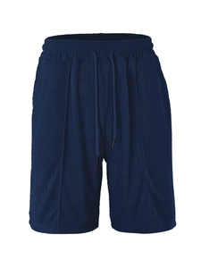 Detail of dark blue men's shorts with waffle knit texture and drawstring elastic waistband