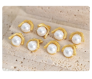 Detailed view of elegant faux pearl stud earrings with gold-plated titanium steel finish