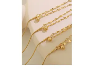Close-up of gold-plated double-layer lip chain bracelet with polished steel bead detail