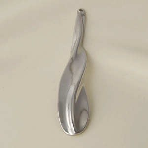Detailed view of silver wave irregular 304 stainless steel pendant with polished finish