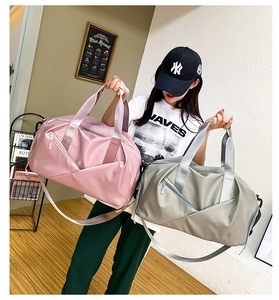 Model showing pink and grey waterproof travel bags with wet dry separation pockets