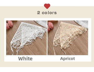 Close-up of white and apricot handmade crochet headscarves with delicate long fringes