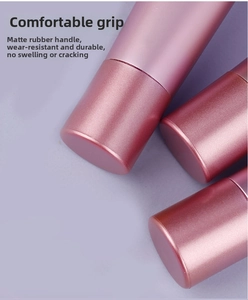 Detail of matte pink makeup brush handles with soft-touch rubber finish for better grip