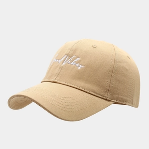 Khaki cotton baseball cap with Good Vibes white embroidery and curved brim in 45-degree view