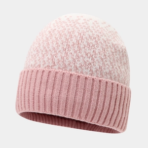 Detail of pink and white snowflake pattern knit hat with ribbed cuff for winter warmth