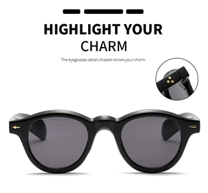 Detail of vintage round sunglasses showing golden triple-star rivets and grey UV lenses