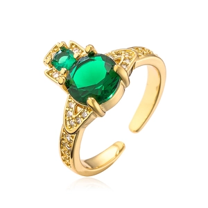 Detailed shot of gold-plated ring with round green zircon stones and micro-pave setting