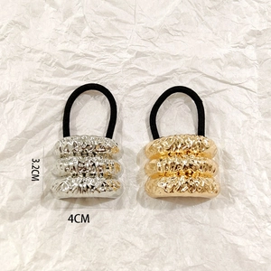 Detail of silver and gold hollow alloy hair cuffs with dimensions 3.2cm by 4cm