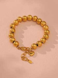 Macro shot of 18k gold plated hollow beads and heart pendant with S.Steel hallmark