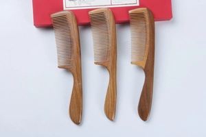 Detailed close-up of natural bamboo hair combs with ergonomic handles on white background