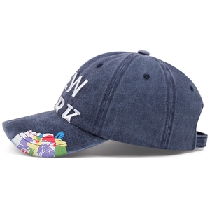 Detail view of navy blue washed cotton baseball cap with New York embroidery and graffiti brim