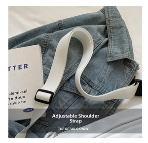 Detail view of durable white canvas shoulder strap with black adjustable buckle and thick webbing