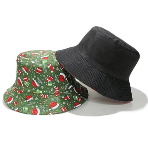 Detail of Christmas bucket hats in black and green cotton with Merry Christmas holiday print