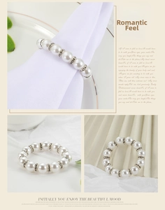 Detail of luxury pearl napkin ring with rhinestones on an elegant white fabric