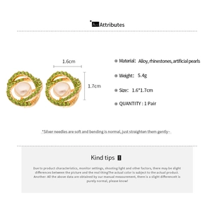 Detailed view of pearl earrings with green rhinestones and 1.6cm by 1.7cm size specs