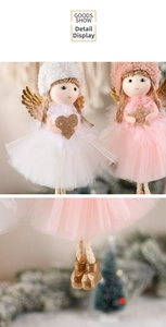 Detail of plush Christmas angel ornaments with tulle skirts and golden wings in soft white and pink