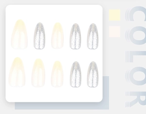 Detail of almond-shaped press-on nails in cream white and silver glitter finish