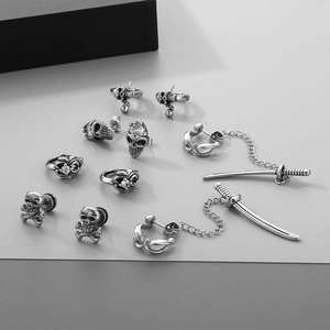 Gothic punk earring set with skull, cross sword, and chain detail in antique silver