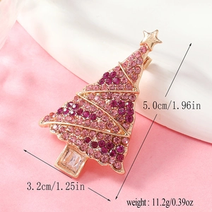 Detailed view of Christmas tree brooch with pink and purple rhinestones and star topper