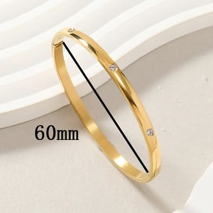 Polished gold titanium steel bangle featuring three inlaid zircons and a 60mm diameter size
