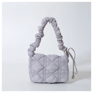 Minimalist light grey quilted nylon crossbody bag with puffy cloud handle and knot detail