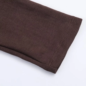 Close-up of brown knit dress sleeve showing detailed stitching and soft ribbed texture
