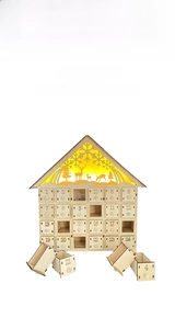 Detail of wooden advent calendar with 24 small drawers and warm LED light deer scene