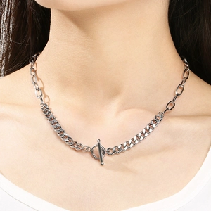 Close-up of dual-chain stainless steel necklace with OT buckle on model neck