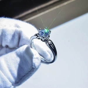 Macro shot of silver ring with six-prong setting showing PT950 stamp and round gemstone