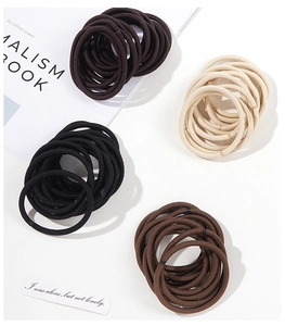 Detail of high-elasticity seamless hair bands in black, brown and beige neutral colors