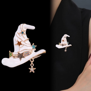 Vintage witch hat brooch in white enamel with gold accents and sparkling crystals