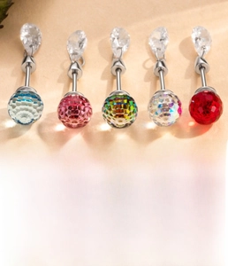 Macro detail of faceted crystal stud earrings in blue pink white and red titanium steel