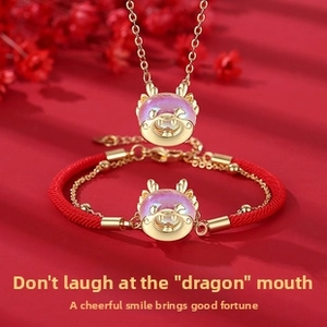 Macro detail of a golden dragon head jewelry set with purple beads on red background
