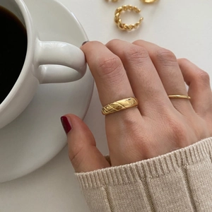 Minimalist 925 sterling silver ring with gold quilted texture worn on pointer finger