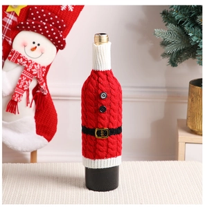 Detail of red knitted Santa Claus wine bottle cover with belt and button accents