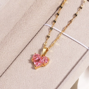 Titanium steel gold necklace with a pink heart zircon pendant in a beige jewelry box