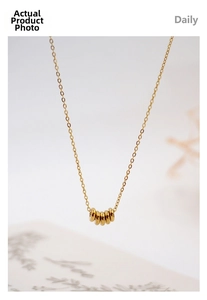 Detail of minimalist gold titanium necklace featuring five interlocking polished rings