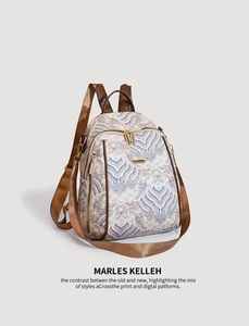 Detail view of ethnic paisley pattern fabric and golden hardware on a backpack